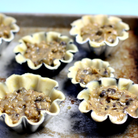 Making mini chocolate chip pies with fluted tart pans!