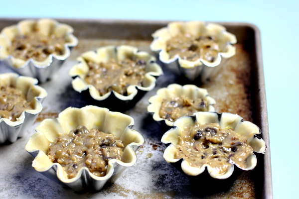 Making mini chocolate chip pies with fluted tart pans!