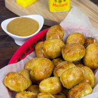 THESE ARE AMAZING! Perfect for gameday appetizers! Stuffed Pretzel Bites with Homemade Honey Mustard Dipping Sauce