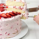 Fresh Strawberry Cake | This cake features loads of fresh strawberries and a light whipped cream topping. It's PERFECT for summer!!
