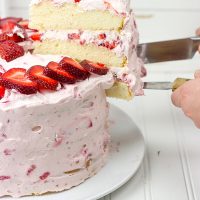 Fresh Strawberry Cake | This cake features loads of fresh strawberries and a light whipped cream topping. It's PERFECT for summer!!