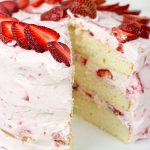 Fresh Strawberry Cake | This cake features loads of fresh strawberries and a light whipped cream topping. It's PERFECT for summer!!