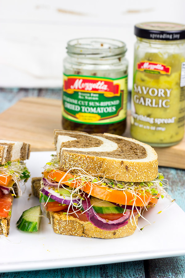 These Sun-Dried Tomato and Garlic Hummus Sandwiches are loaded with delicious, creamy hummus and fresh, crispy veggies. They're the perfect summer lunch!