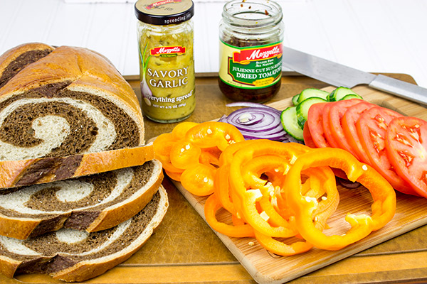 These Sun-Dried Tomato and Garlic Hummus Sandwiches are loaded with delicious, creamy hummus and fresh, crispy veggies. They're the perfect summer lunch!