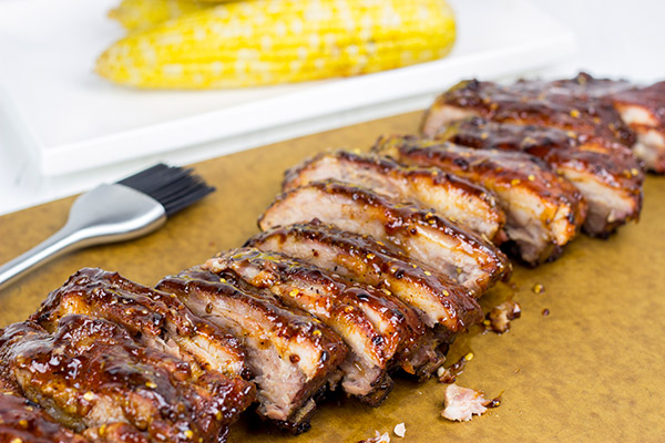 Nothing says summer like grilling ribs in your backyard. These Sweet Chili Glazed Baby Back Ribs offer a fun twist on an American classic!