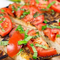 Instead of toasting bread, throw it on the grill! This Grilled Bruschetta makes for the perfect summer appetizer (or dinner)!