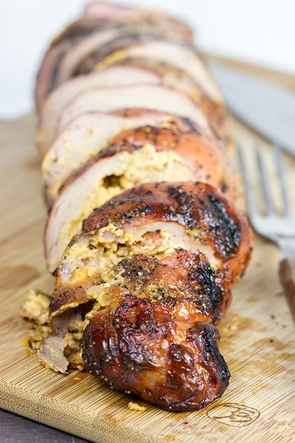 Stuffed with crispy bacon, diced jalapenos and cream cheese, these Bacon & Jalapeno Stuffed Grilled Pork Tenderloins are a delicious grilled game day treat!