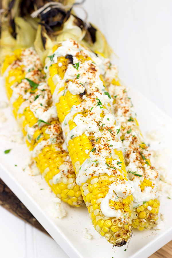 This Mexican Street Corn is covered in crema, grated Parmesan, lime juice and feta cheese. It's messy...and VERY tasty!