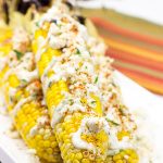 This Mexican Street Corn is covered in crema, grated Parmesan, lime juice and feta cheese. It's messy...and VERY tasty!