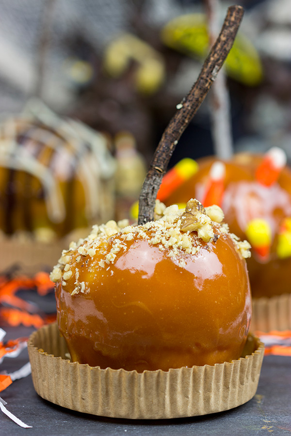Homemade caramel apples are an easy and fun seasonal treat! Grab some juicy apples and top them with caramel, chocolate and chopped nuts. #ad #WalmartProduce