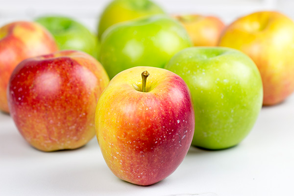 Homemade caramel apples are an easy and fun seasonal treat! Grab some juicy apples and top them with caramel, chocolate and chopped nuts. #ad #WalmartProduce