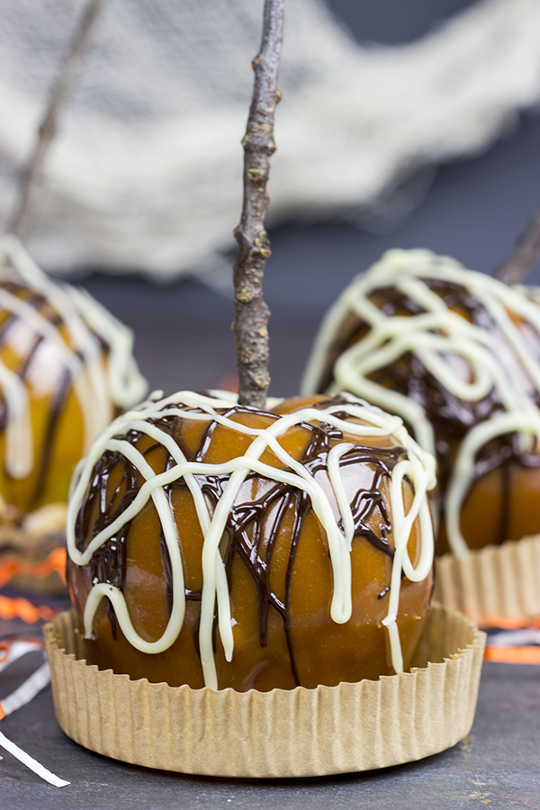 Homemade caramel apples are an easy and fun seasonal treat! Grab some juicy apples and top them with caramel, chocolate and chopped nuts. #ad #WalmartProduce