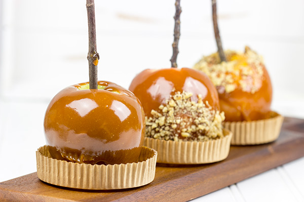 Homemade caramel apples are an easy and fun seasonal treat! Grab some juicy apples and top them with caramel, chocolate and chopped nuts. #ad #WalmartProduce
