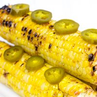 This Spicy Maple Grilled Corn is brushed with a delicious hot sauce + maple syrup combo. It's the perfect side dish for the grill!