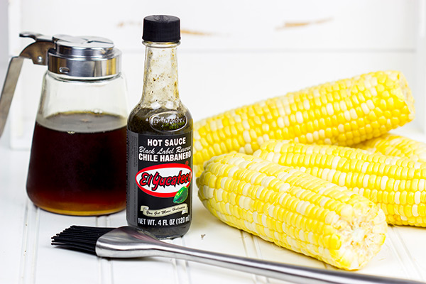 This Spicy Maple Grilled Corn is brushed with a delicious hot sauce + maple syrup combo. It's the perfect side dish for the grill!