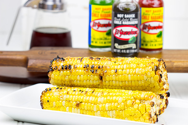 This Spicy Maple Grilled Corn is brushed with a delicious hot sauce + maple syrup combo. It's the perfect side dish for the grill!