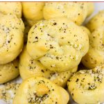 Brushed with melted butter, minced garlic and shaved Parmesan cheese, these Parmesan Garlic Knots are a delicious appetizer for gameday!