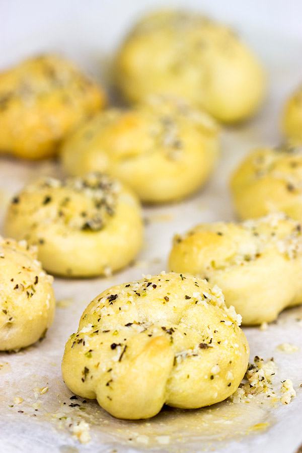 Brushed with melted butter, minced garlic and shaved Parmesan cheese, these Parmesan Garlic Knots are a delicious appetizer for gameday!