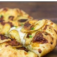 Looking for a delicious and unique pizza topping? Try some spuds! This Roasted Potato, Bacon and Onion Pizza is the perfect comfort food on a cold night!