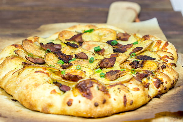 Looking for a delicious and unique pizza topping? Try some spuds! This Roasted Potato, Bacon and Onion Pizza is the perfect comfort food on a cold night!