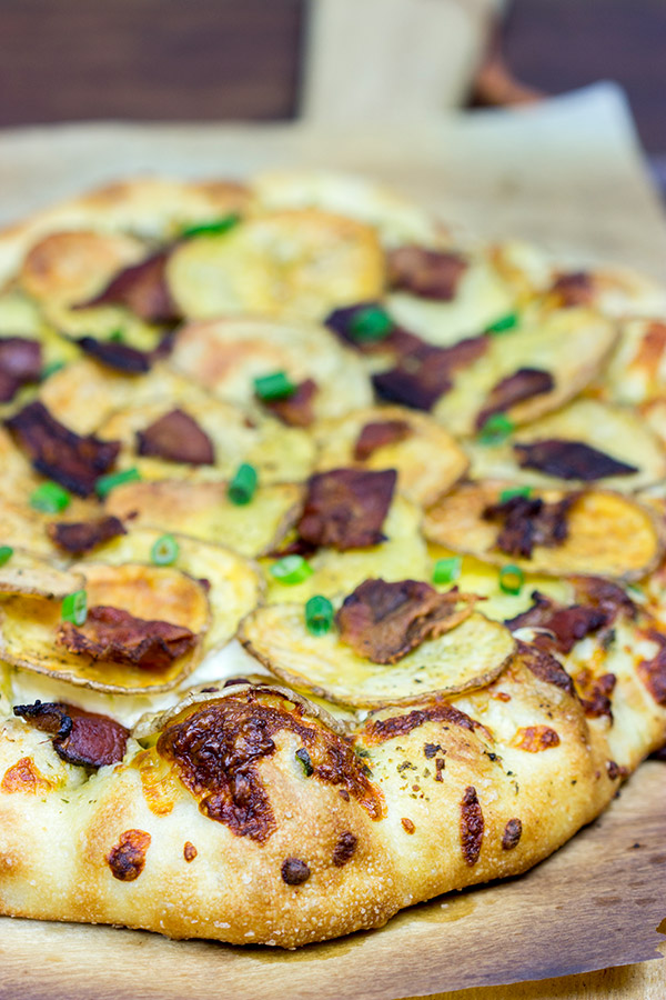 Looking for a delicious and unique pizza topping? Try some spuds! This Roasted Potato, Bacon and Onion Pizza is the perfect comfort food on a cold night!