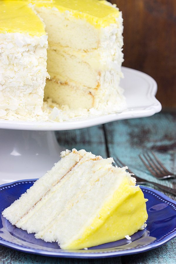 Decadent coconut flakes...sweet vanilla buttercream...tart lemon curd. One slice of this Lemon Coconut Cake will whisk you away to a warm Caribbean island!