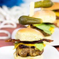 Stuffed with cheese and then topped with more cheese, these Triple Cheddar Bacon Sliders are the perfect snack to serve during the big game!