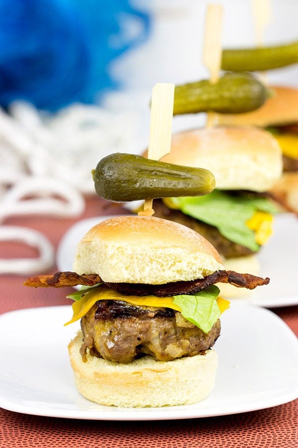 Stuffed with cheese and then topped with more cheese, these Triple Cheddar Bacon Sliders are the perfect snack to serve during the big game!