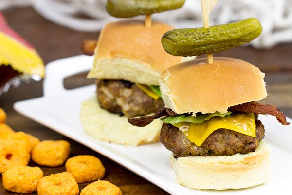 Stuffed with cheese and then topped with more cheese, these Triple Cheddar Bacon Sliders are the perfect snack to serve during the big game!