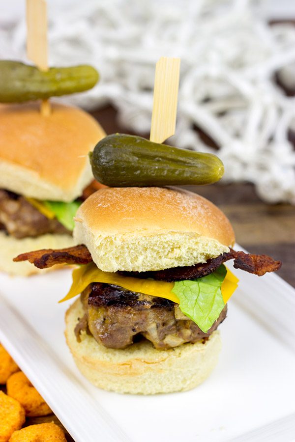 Stuffed with cheese and then topped with more cheese, these Triple Cheddar Bacon Sliders are the perfect snack to serve during the big game!