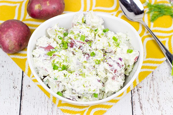 This lightened-up New England Potato Salad packs a flavor punch thanks to a handful of shredded horseradish cheddar cheese. It's a summer picnic classic!