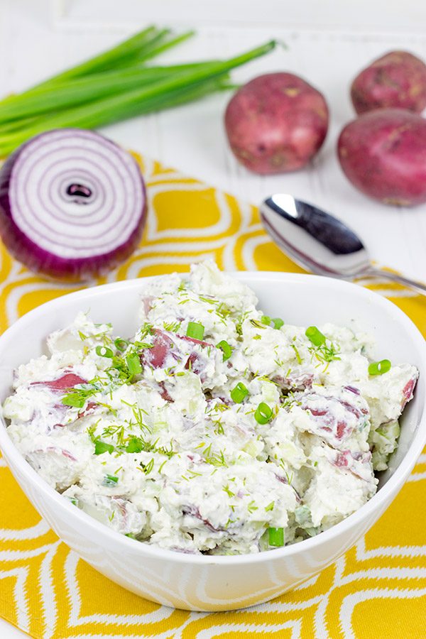 This lightened-up New England Potato Salad packs a flavor punch thanks to a handful of shredded horseradish cheddar cheese. It's a summer picnic classic!