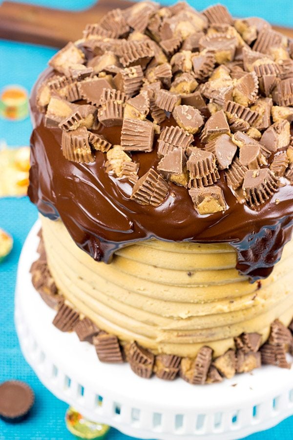 This Reese's Chocolate Peanut Butter Cake features a rich, moist chocolate cake covered in a decadent peanut butter frosting. Garnish with chopped peanut butter cups for a delicious dessert!