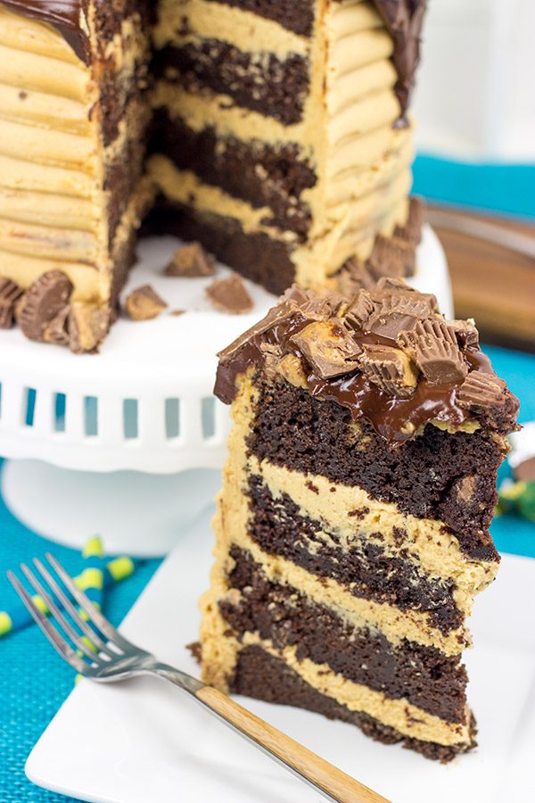 This Reese's Chocolate Peanut Butter Cake features a rich, moist chocolate cake covered in a decadent peanut butter frosting. Garnish with chopped peanut butter cups for a delicious dessert!