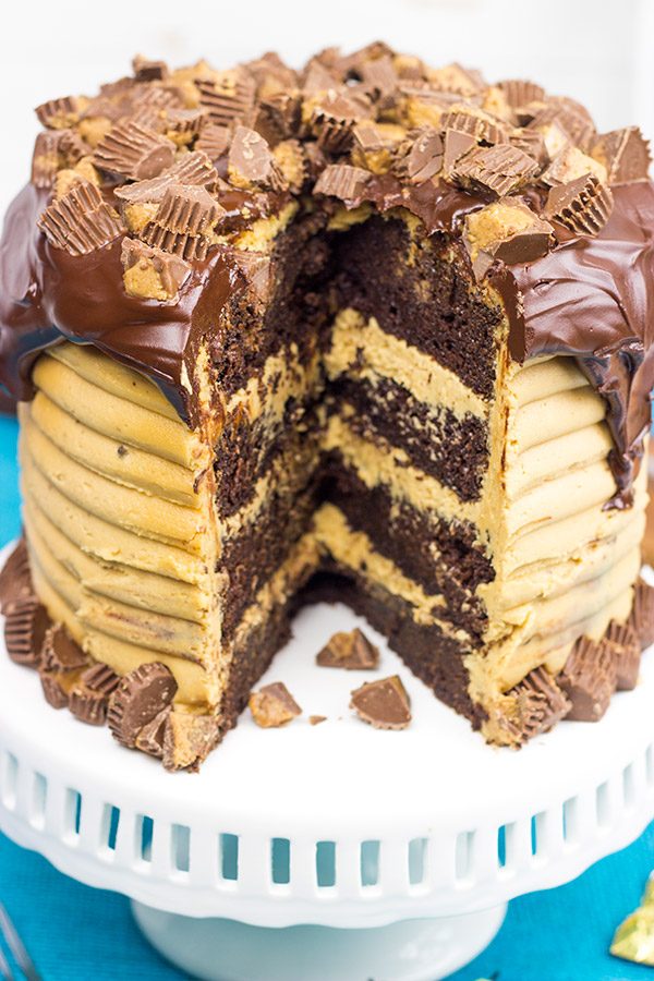 This Reese's Chocolate Peanut Butter Cake features a rich, moist chocolate cake covered in a decadent peanut butter frosting. Garnish with chopped peanut butter cups for a delicious dessert!