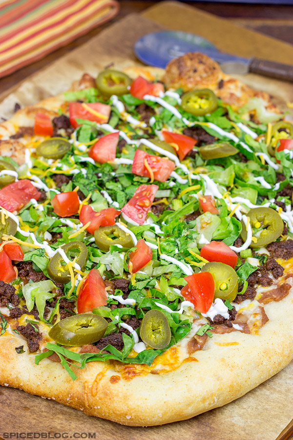 Topped with seasoned beef and your favorite taco ingredients, this Taco Pizza is a delicious way to celebrate the arrival of warm(er) weather!