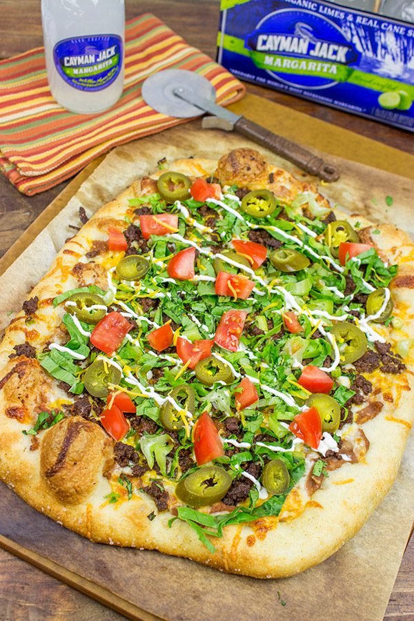 Topped with seasoned beef and your favorite taco ingredients, this Taco Pizza is a delicious way to celebrate the arrival of warm(er) weather!