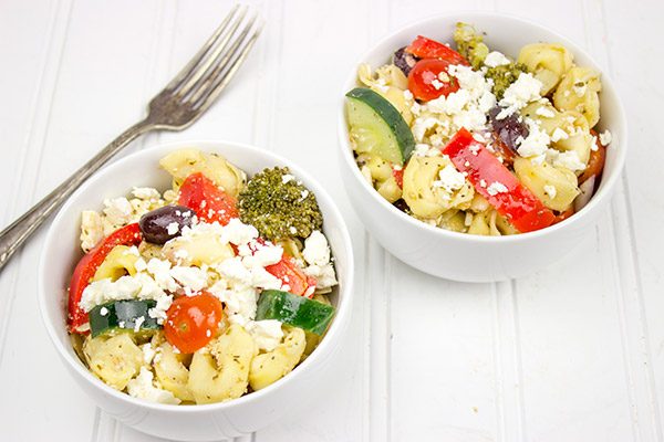This Greek Tortellini Pasta Salad is loaded with all of your favorite Greek salad toppings...and it's perfect for summer picnics!