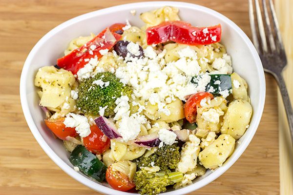 This Greek Tortellini Pasta Salad is loaded with all of your favorite Greek salad toppings...and it's perfect for summer picnics!