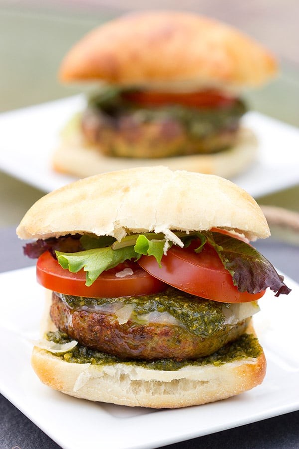 Looking for a unique recipe for the grill? Complete with pesto and Parmesan cheese, these Pesto Chicken Burgers are sure to be a hit this summer!