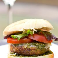 Looking for a unique recipe for the grill? Complete with pesto and Parmesan cheese, these Pesto Chicken Burgers are sure to be a hit this summer!