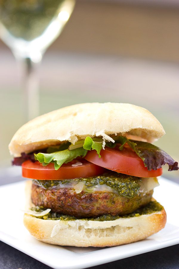 Looking for a unique recipe for the grill? Complete with pesto and Parmesan cheese, these Pesto Chicken Burgers are sure to be a hit this summer!