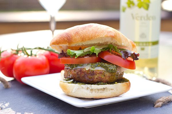 Looking for a unique recipe for the grill? Complete with pesto and Parmesan cheese, these Pesto Chicken Burgers are sure to be a hit this summer!