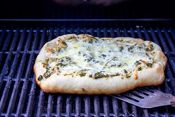 Brushed with pesto and then topped with fresh tomatoes and arugula, this Bruschetta Pizza is a delicious summer meal!
