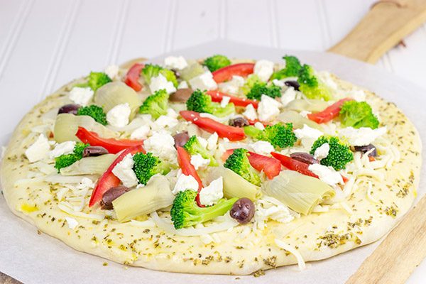 Topped with artichokes, olives and feta, this Greek Pizza is perfect for weekend pizza night!