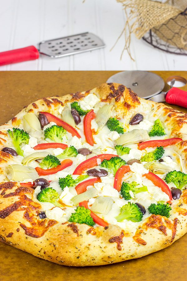 Topped with artichokes, olives and feta, this Greek Pizza is perfect for weekend pizza night!