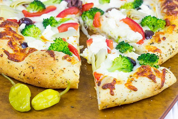 Topped with artichokes, olives and feta, this Greek Pizza is perfect for weekend pizza night!