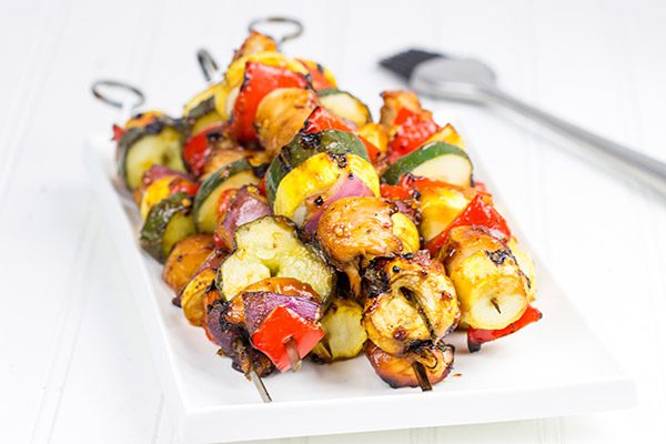 Brushed with a quick and easy glaze, these Spicy Honey BBQ Chicken Skewers make for one heck of a tasty dinner on the grill!