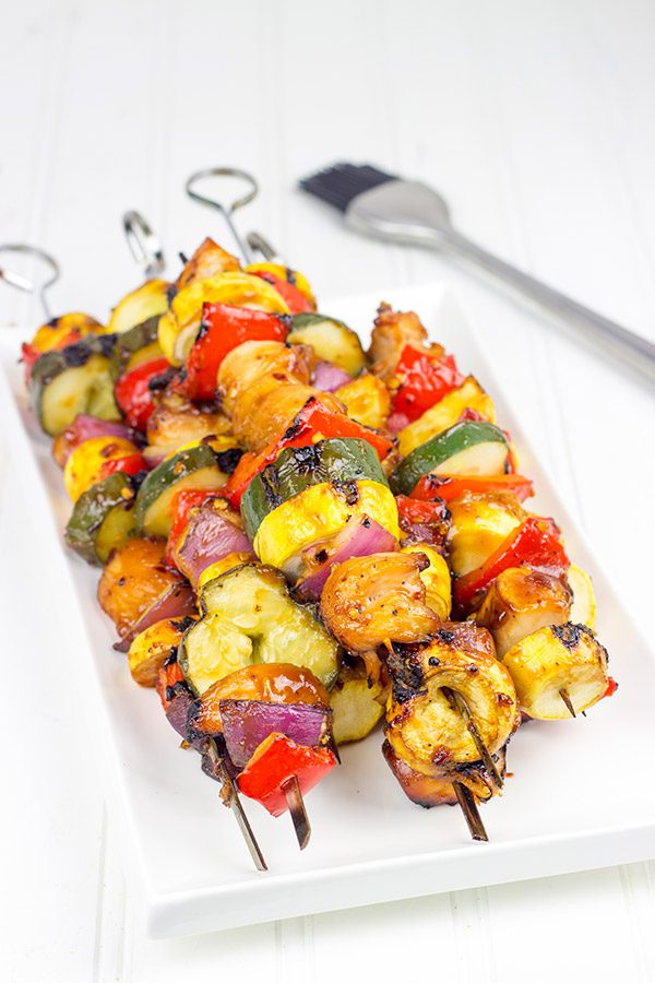 Brushed with a quick and easy glaze, these Spicy Honey BBQ Chicken Skewers make for one heck of a tasty dinner on the grill!