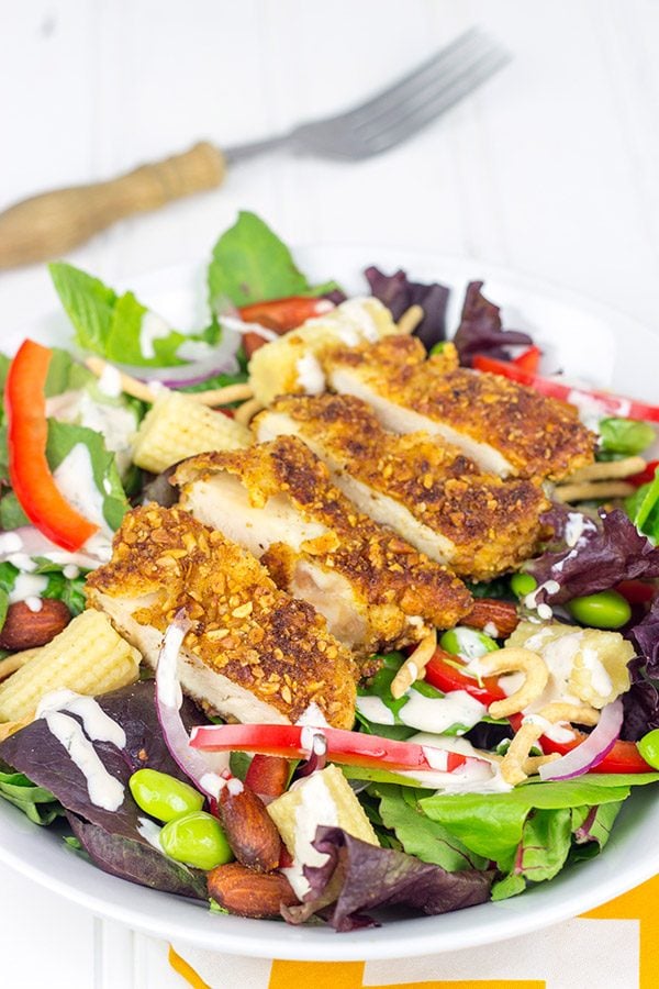 Topped with sriracha almond-encrusted chicken and a sriracha ranch dressing, this Sriracha Almond Chicken Salad makes for a tasty summer lunch!
